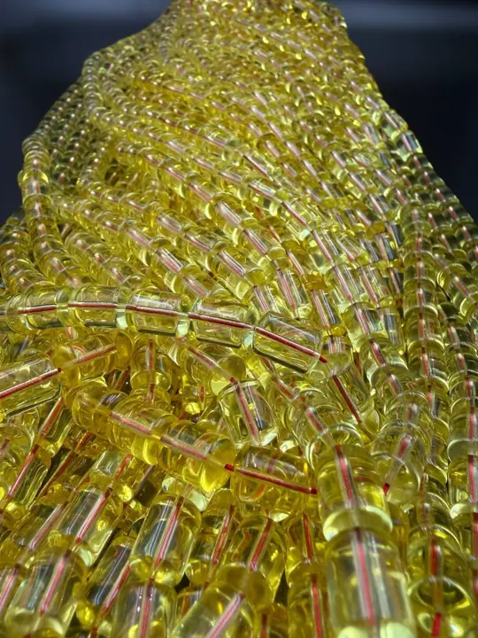 The batch, hanging — amber misbaha strands in production quantity at the VIAMBER atelier